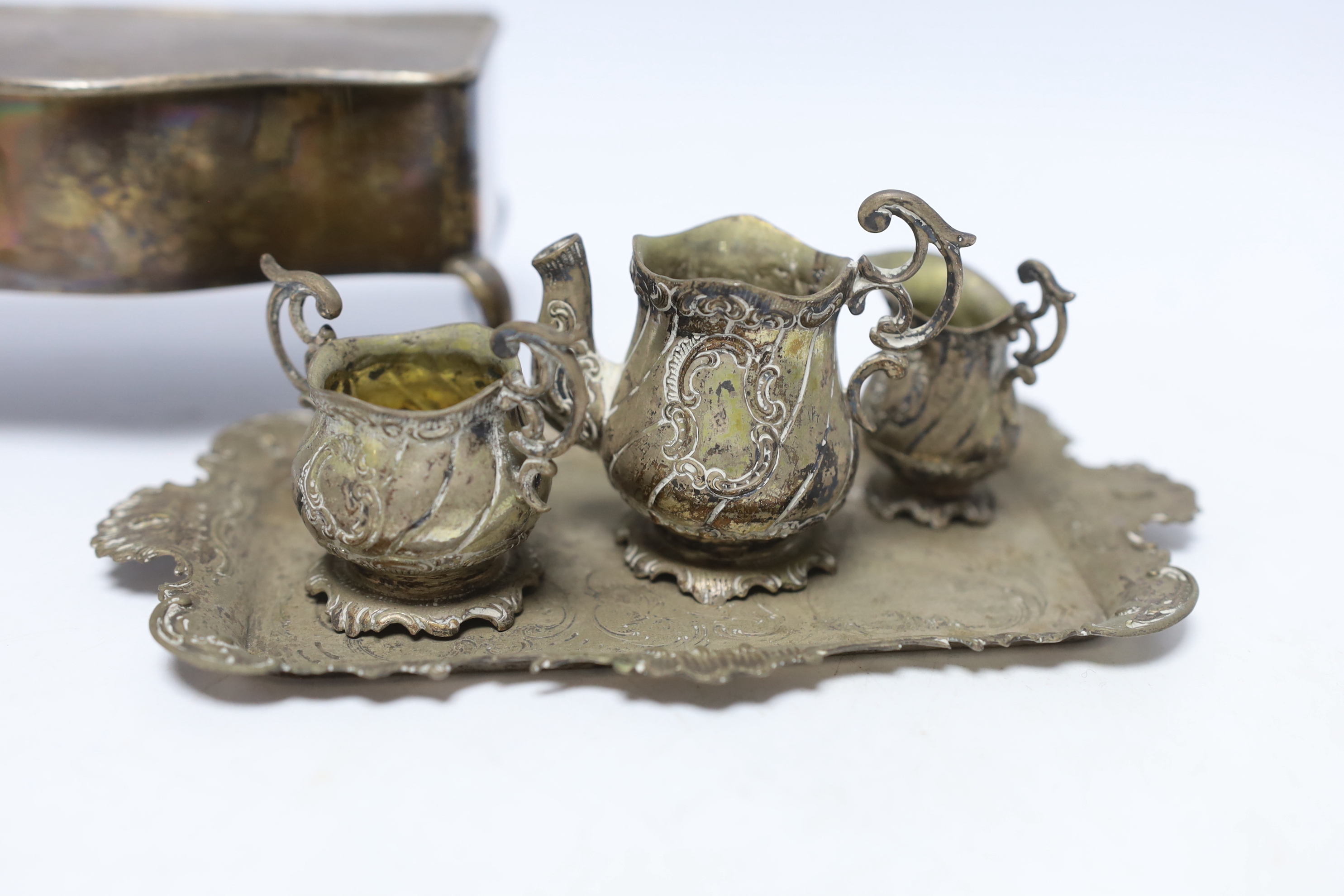 A German Hanau white metal miniature tea set and tray, tray 18.2cm, together with a George V silver mounted trinket box, London, 1922.